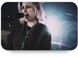 Image of a woman singing into a microphone