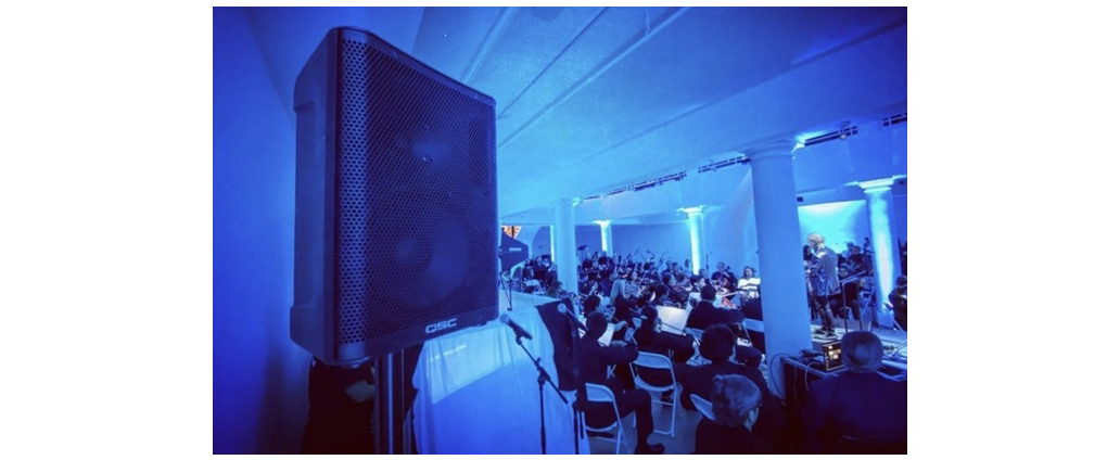 QSC loudspeaker setup at a full venue