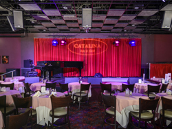 view of the stage and dining tables at the Catalina Jazz Club