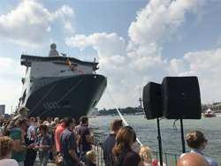QSC pole mounted loudspeakers at Rotterdam Port with a large ship in the background