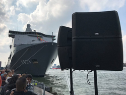 QSC pole mounted loudspeakers at Rotterdam Port with a large ship in the background