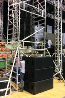 Production employee setting up QSC Subwoofers