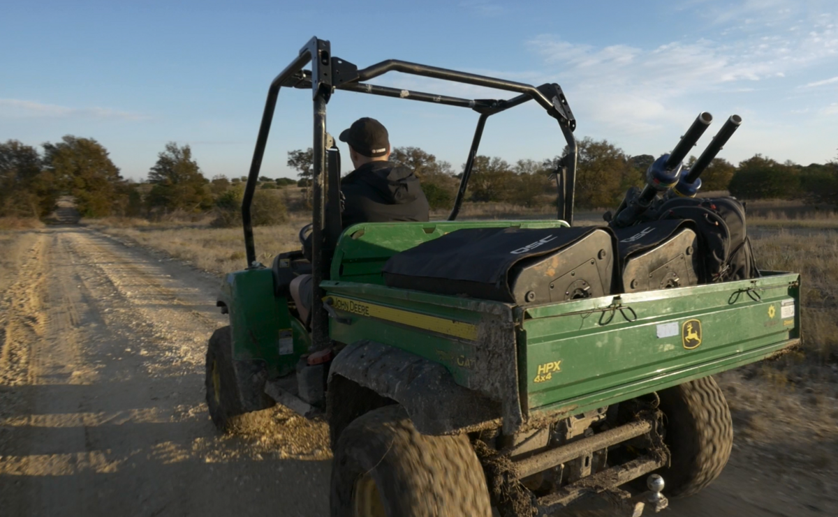 An ATV transporting QSC speakers with their Outdoor covers